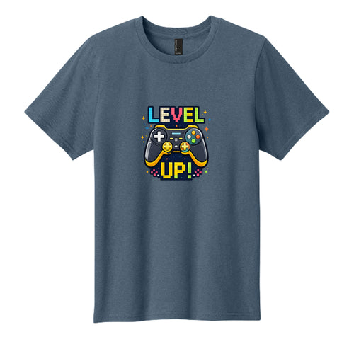 Colorful kids t-shirt graphic featuring a retro video game controller with pixel-style text that says Level Up and bright arcade star accents.